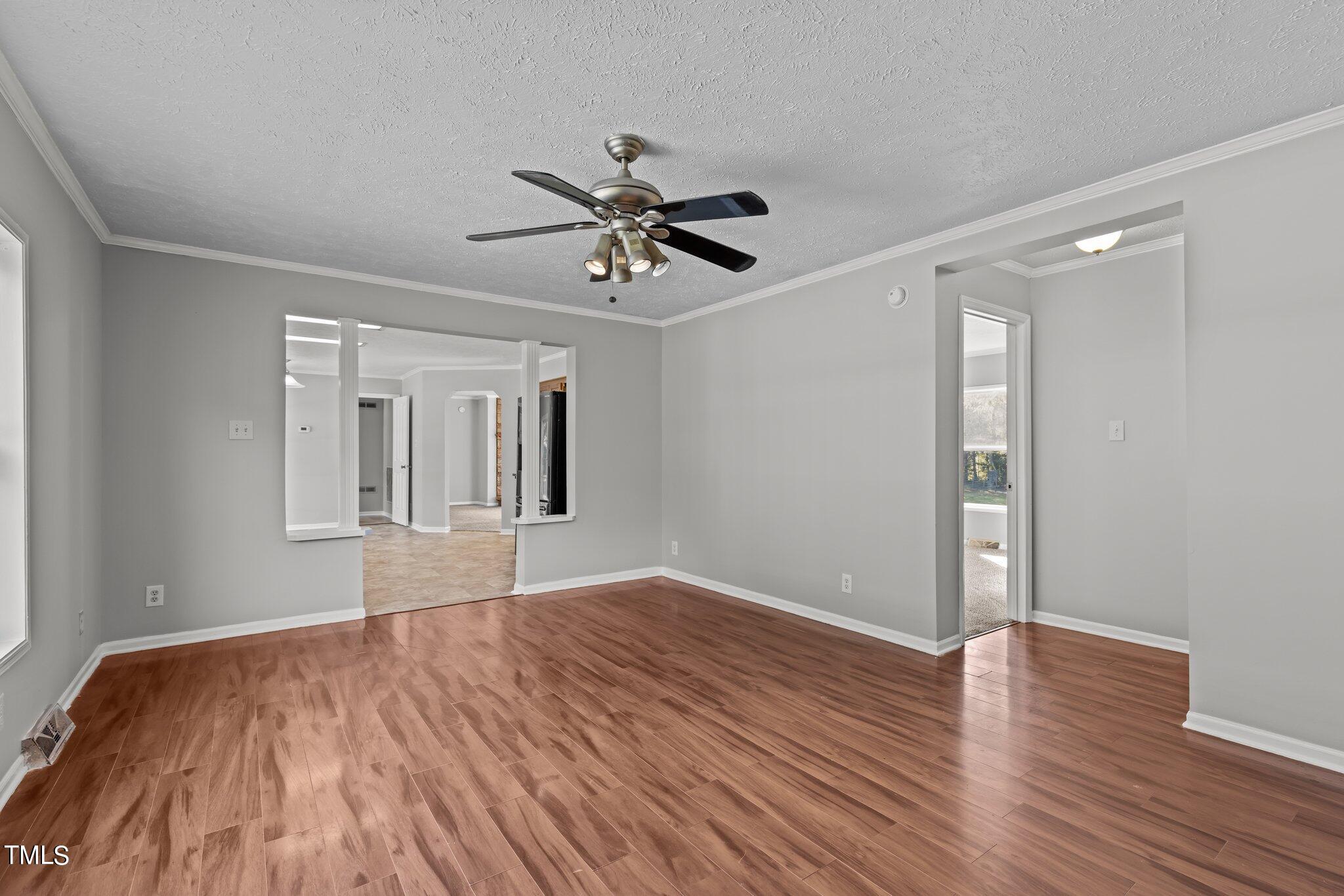 89 Munday Road Roxboro, NC 27574 - Photo 3 of 46 a view of empty room with wooden floor and fan