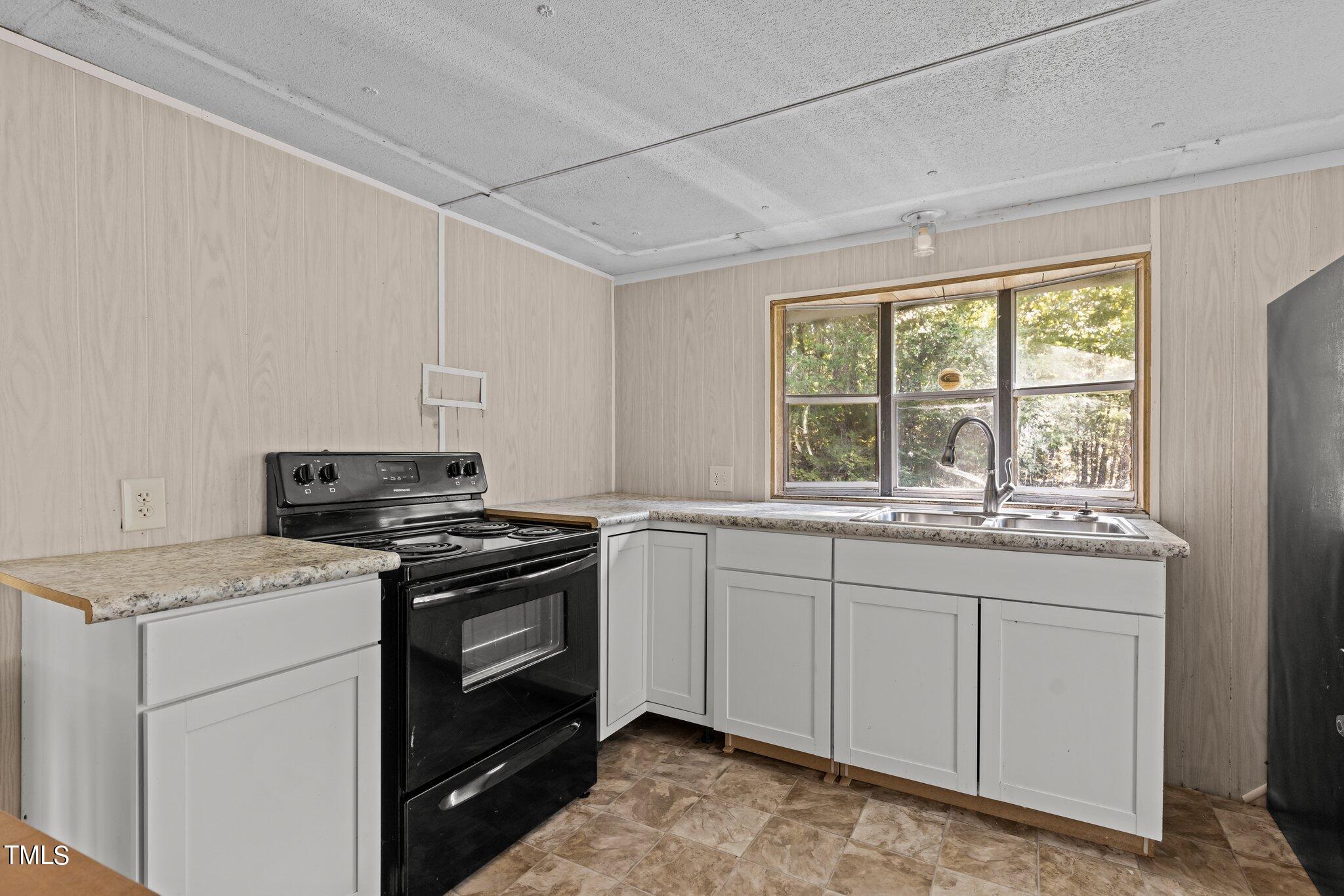 89 Munday Road Roxboro, NC 27574 - Photo 40 of 46 a kitchen with a stove and a sink