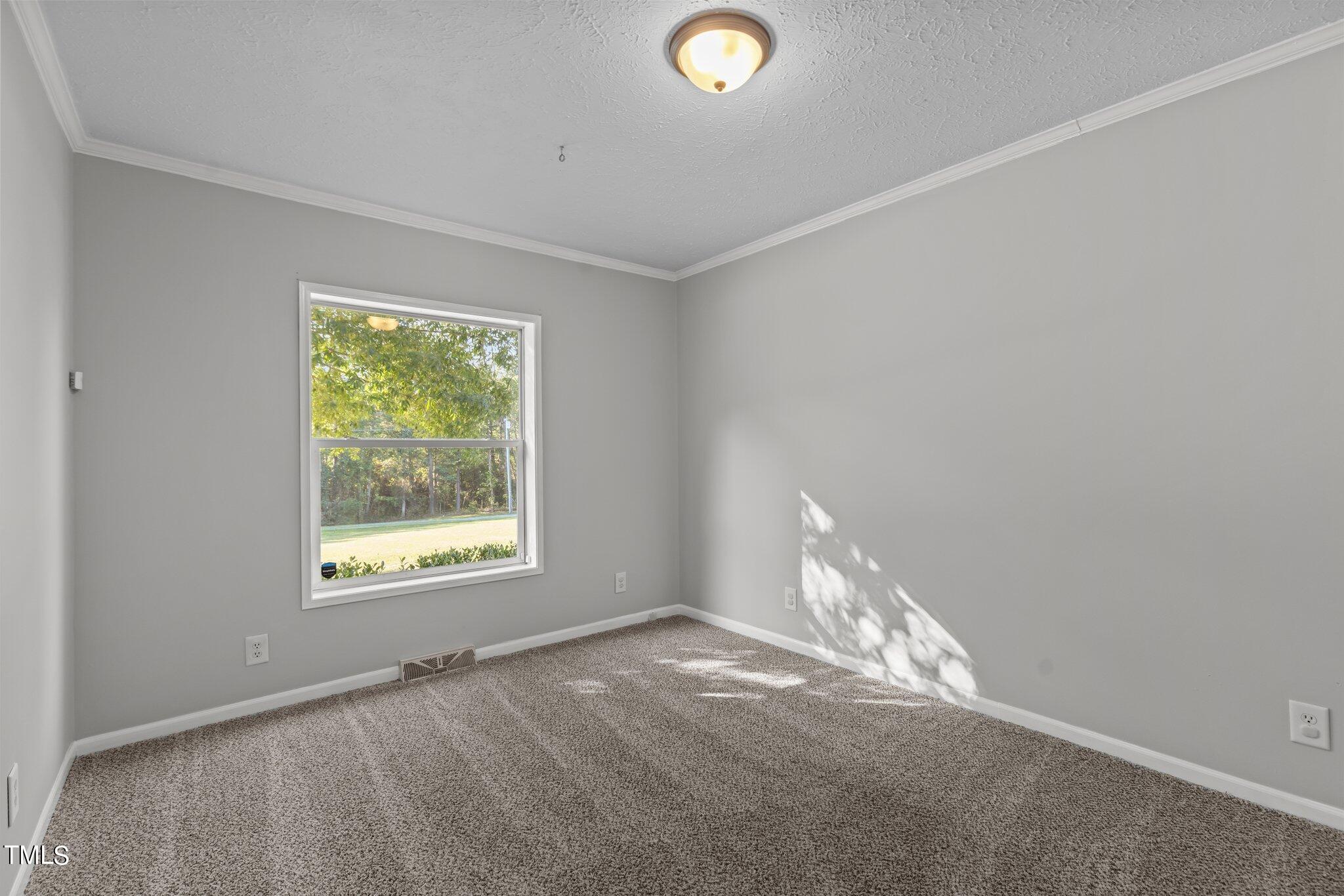 89 Munday Road Roxboro, NC 27574 - Photo 6 of 46 an empty room with a empty space and a window