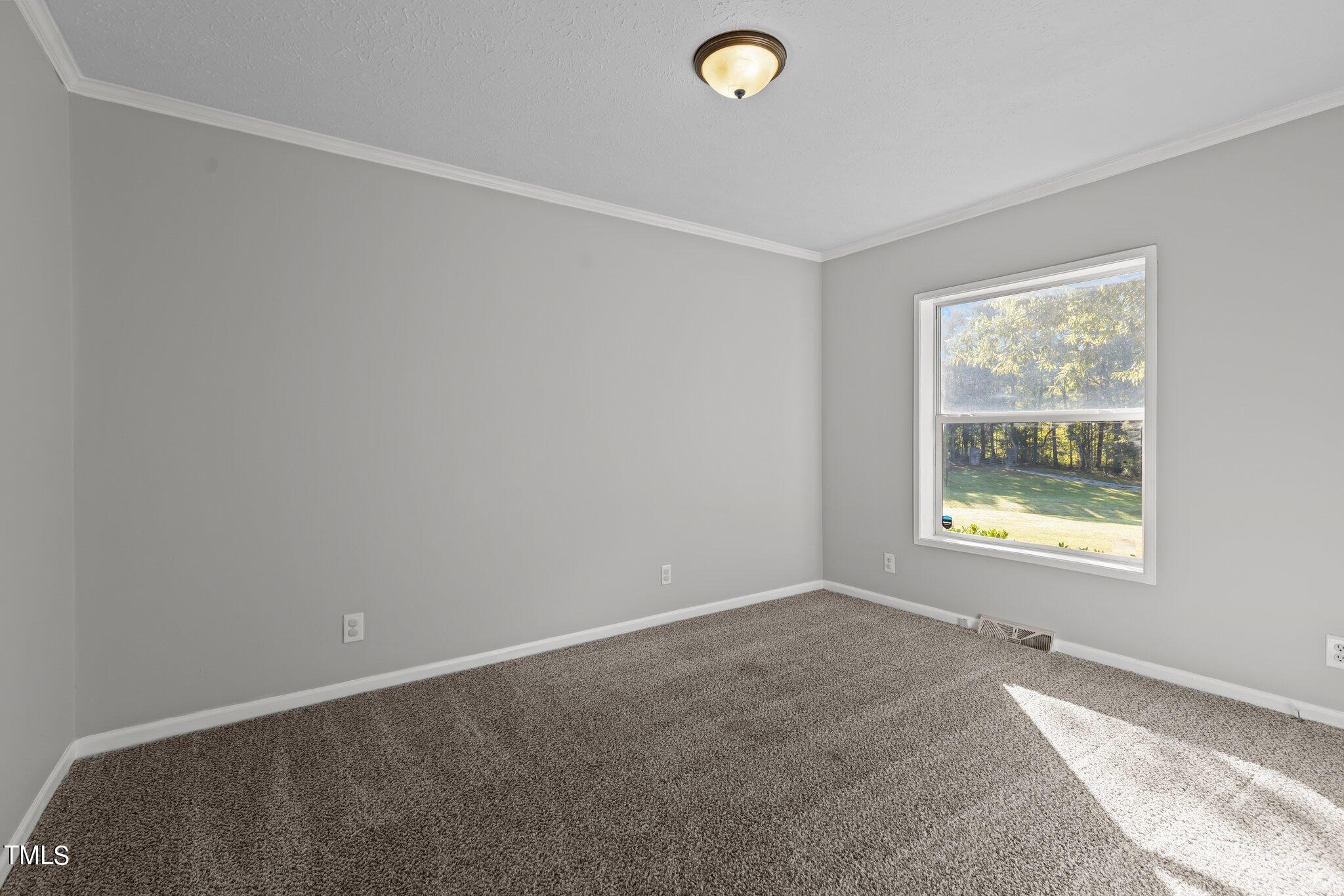 89 Munday Road Roxboro, NC 27574 - Photo 7 of 46 an empty room with windows