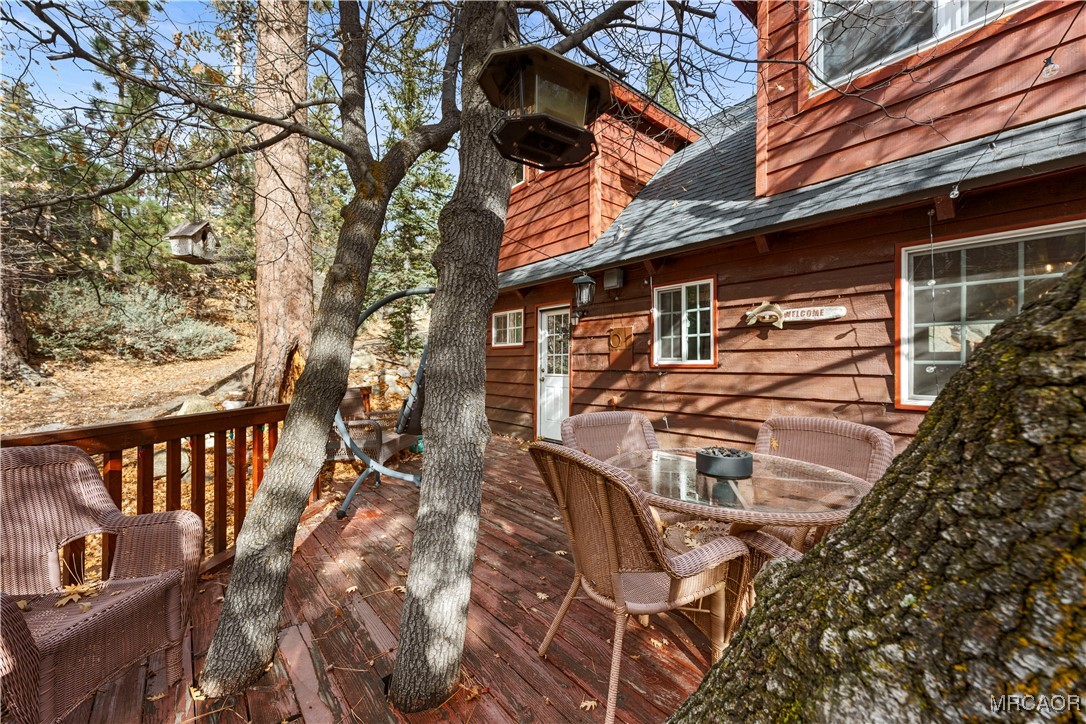 1289 Canyon Road Fawnskin, CA 92333 - Photo 11 of 23 a backyard of a house with table and chairs