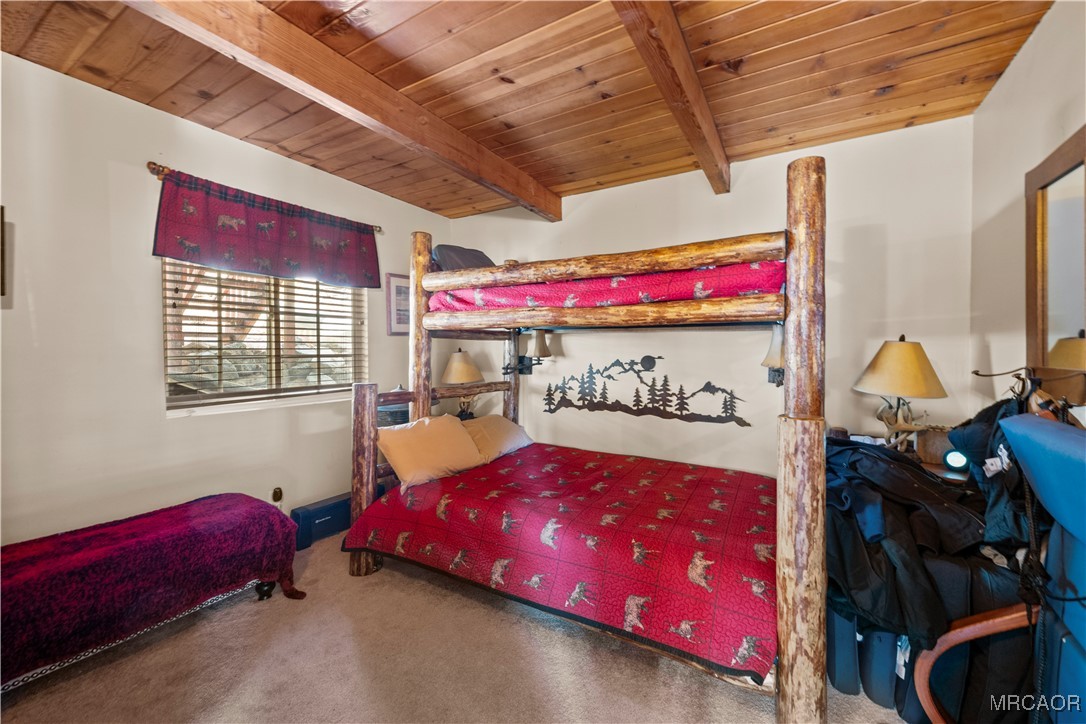 1289 Canyon Road Fawnskin, CA 92333 - Photo 14 of 23 a bedroom with a bed and a window