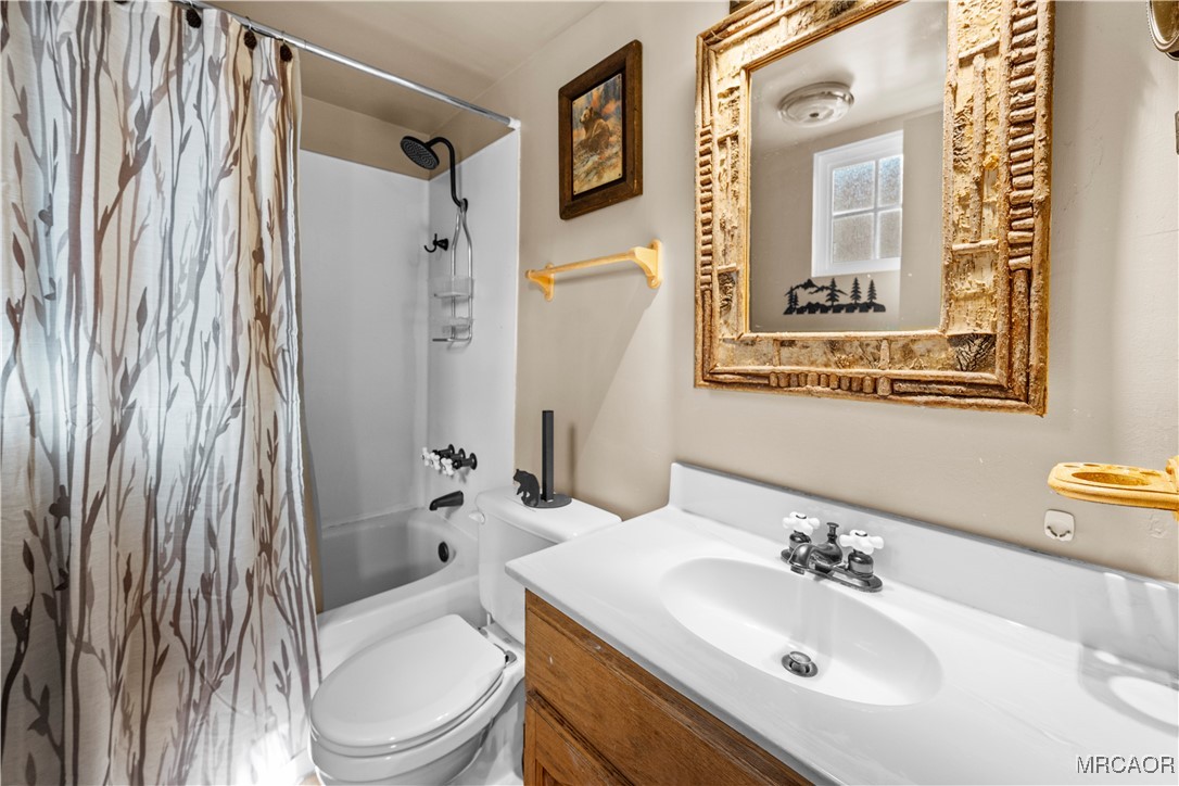 1289 Canyon Road Fawnskin, CA 92333 - Photo 16 of 23 a bathroom with a sink toilet and shower