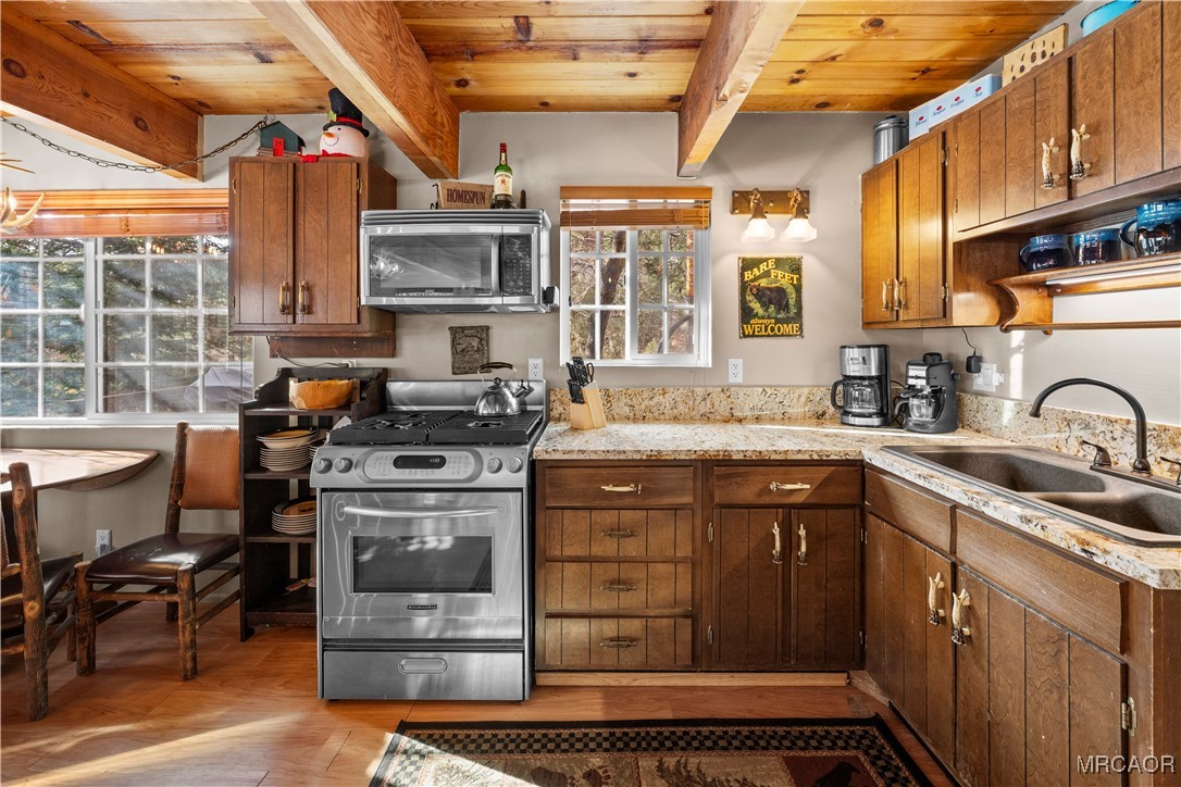 1289 Canyon Road Fawnskin, CA 92333 - Photo 3 of 23 a kitchen with stainless steel appliances granite countertop a stove and a sink