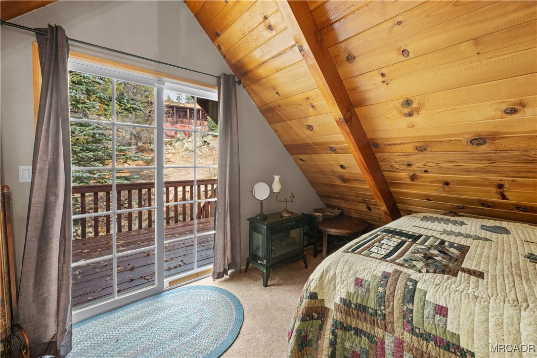 1289 Canyon Road Fawnskin, CA 92333 - Photo 5 of 23 a bedroom with a bed and wooden floor