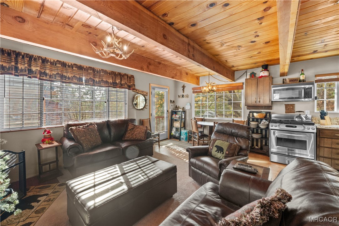 1289 Canyon Road Fawnskin, CA 92333 - Photo 23 of 23 a living room with furniture and a floor to ceiling window