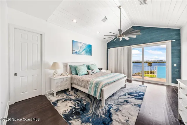 a living room with furniture a fireplace and a large window