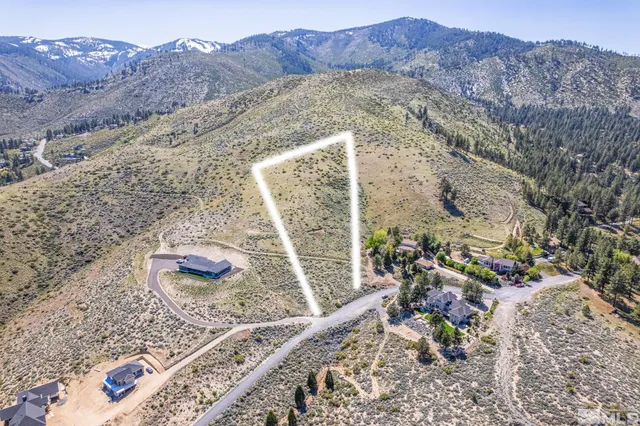 a view of a backyard with table and chairs