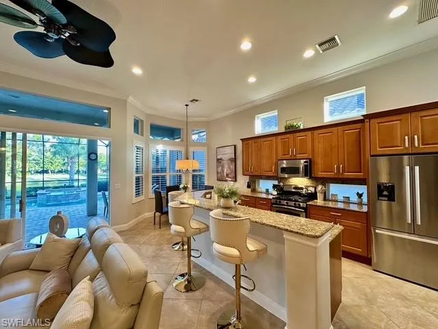 a kitchen with stainless steel appliances kitchen island granite countertop a sink and cabinets