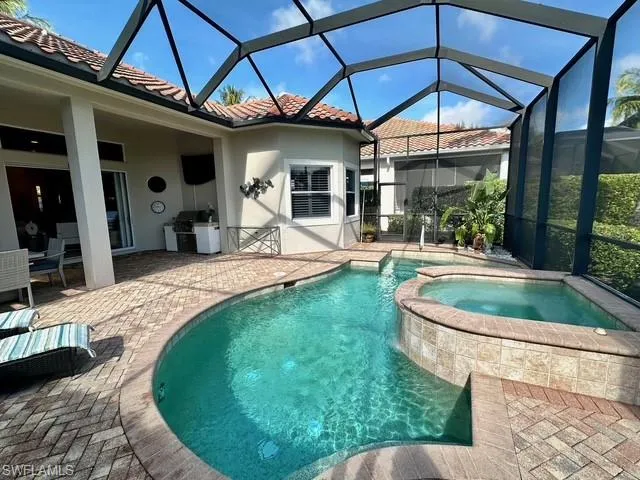 a patio with a table and chairs under an umbrella