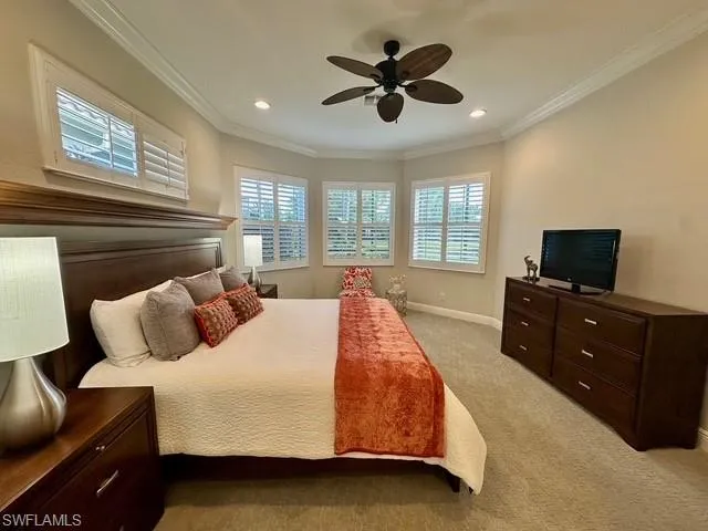 a spacious bedroom with a bed and a flat screen tv