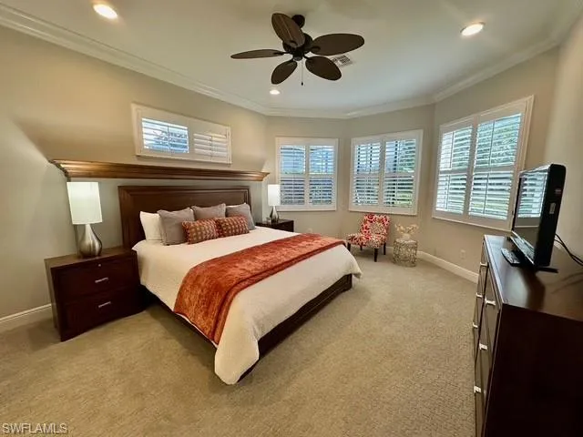 a bedroom with a bed flat screen tv and window