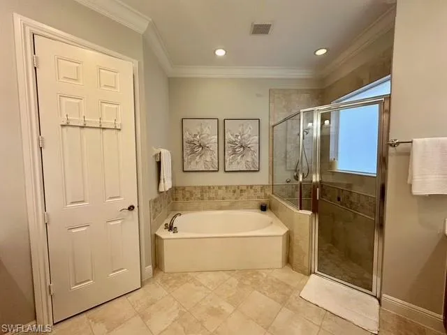 a bathroom with a tub a toilet a sink and shower