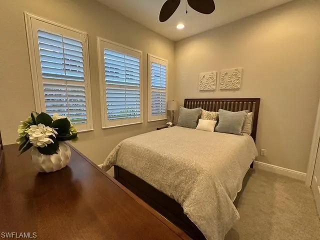 a bed sitting in a bedroom next to a window
