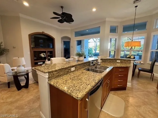 a kitchen with a stove and a view of living room