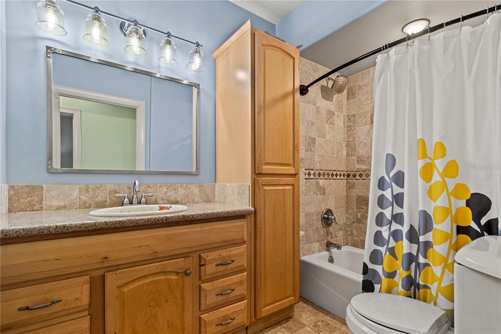 6515 Dimarco Road Tampa, FL 33634 - Photo 60 of 66 a bathroom with a sink a toilet and shower