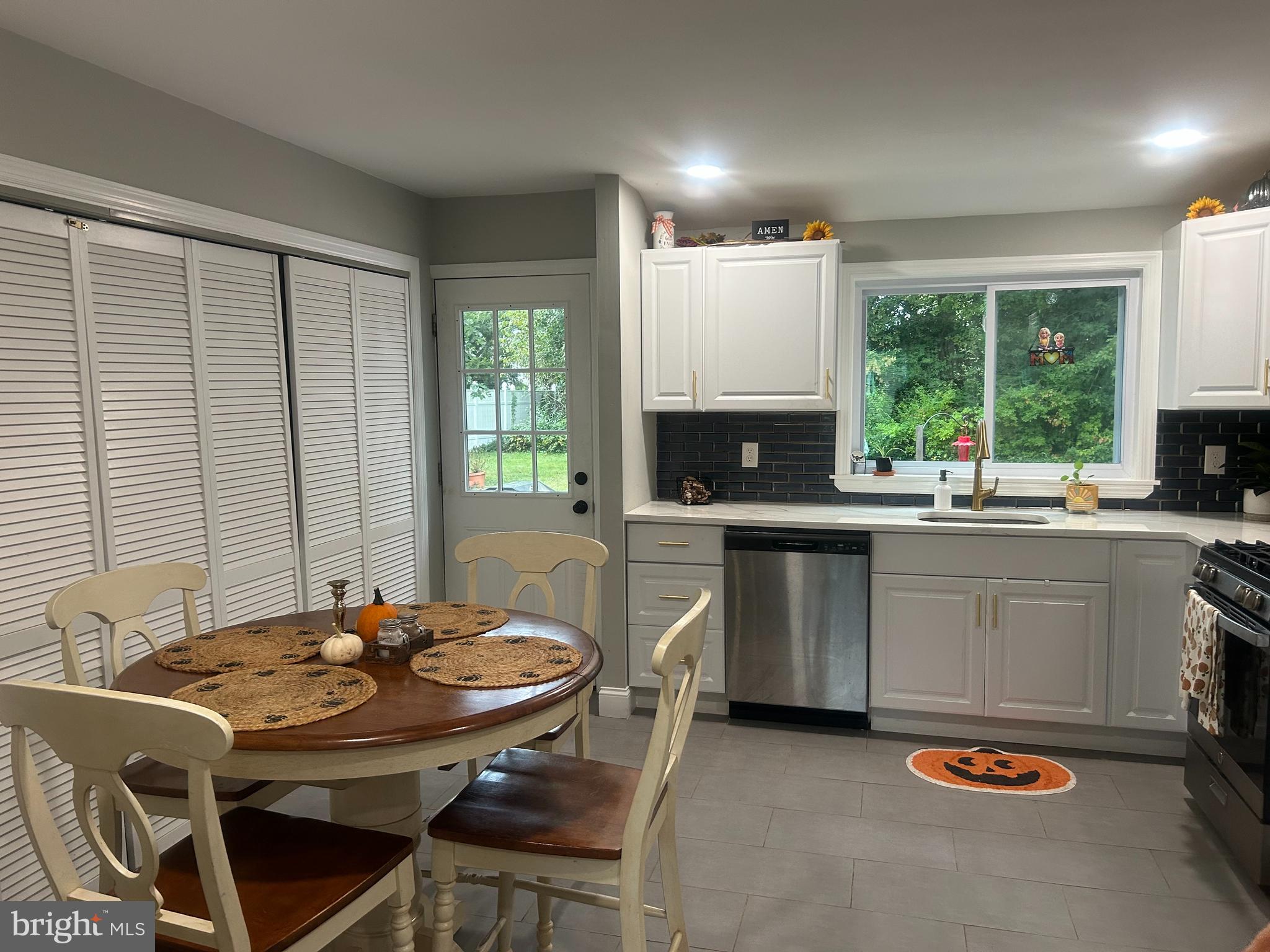 22 Bettlewood Road Marlton, NJ 08053 - Photo 6 of 15 a kitchen with a table chairs stove and microwave