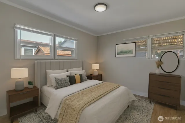 a bedroom with a bed a dresser and window