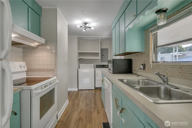 a kitchen with a sink and a refrigerator