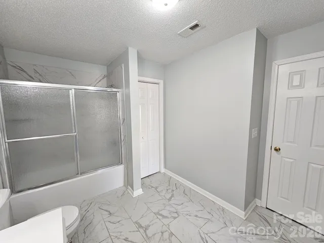 a bathroom with a shower and toilet