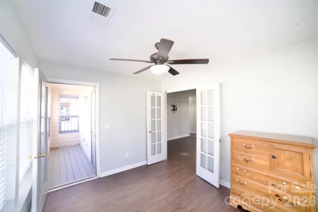 a view of a hallway with closet and wooden floor