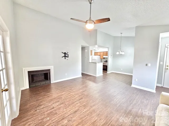 a view of a livingroom with a fireplace and wooden floor