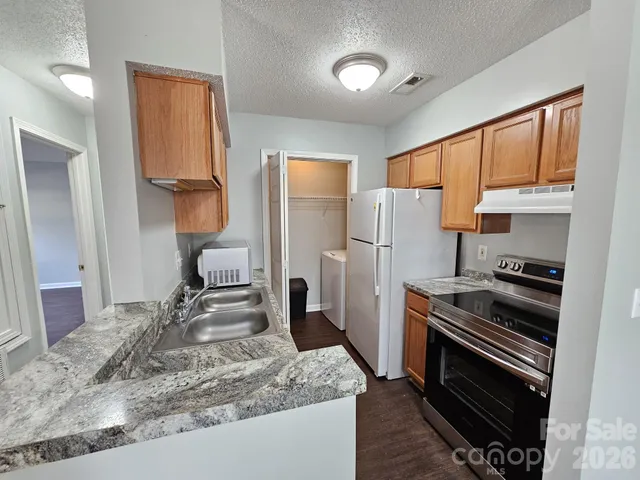 a kitchen with a refrigerator and a sink