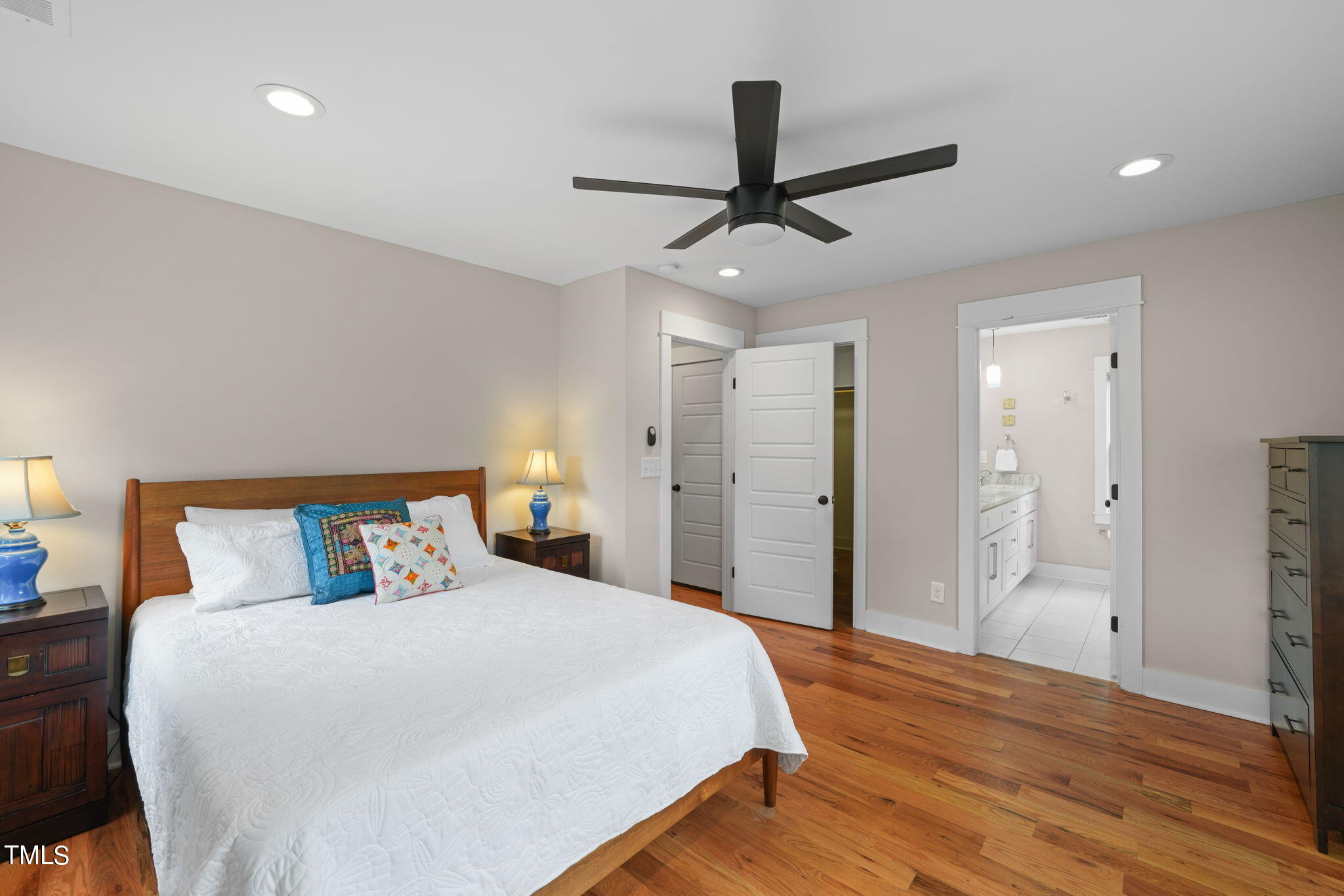 610 Gray Avenue Durham, NC 27701 - Photo 23 of 42 a bedroom with a bed and a ceiling fan