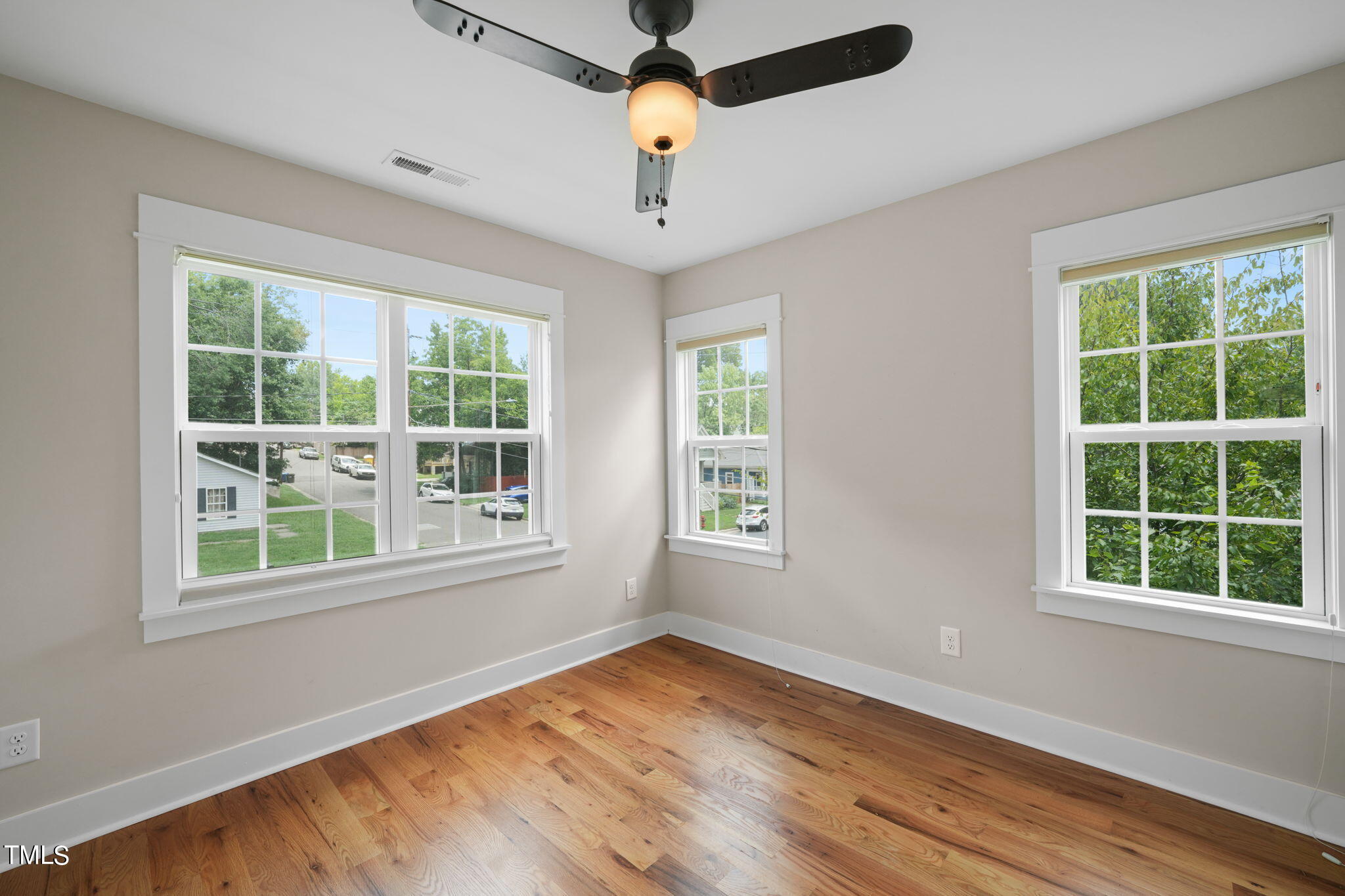 610 Gray Avenue Durham, NC 27701 - Photo 31 of 42 a view of empty room with wooden floor and fan