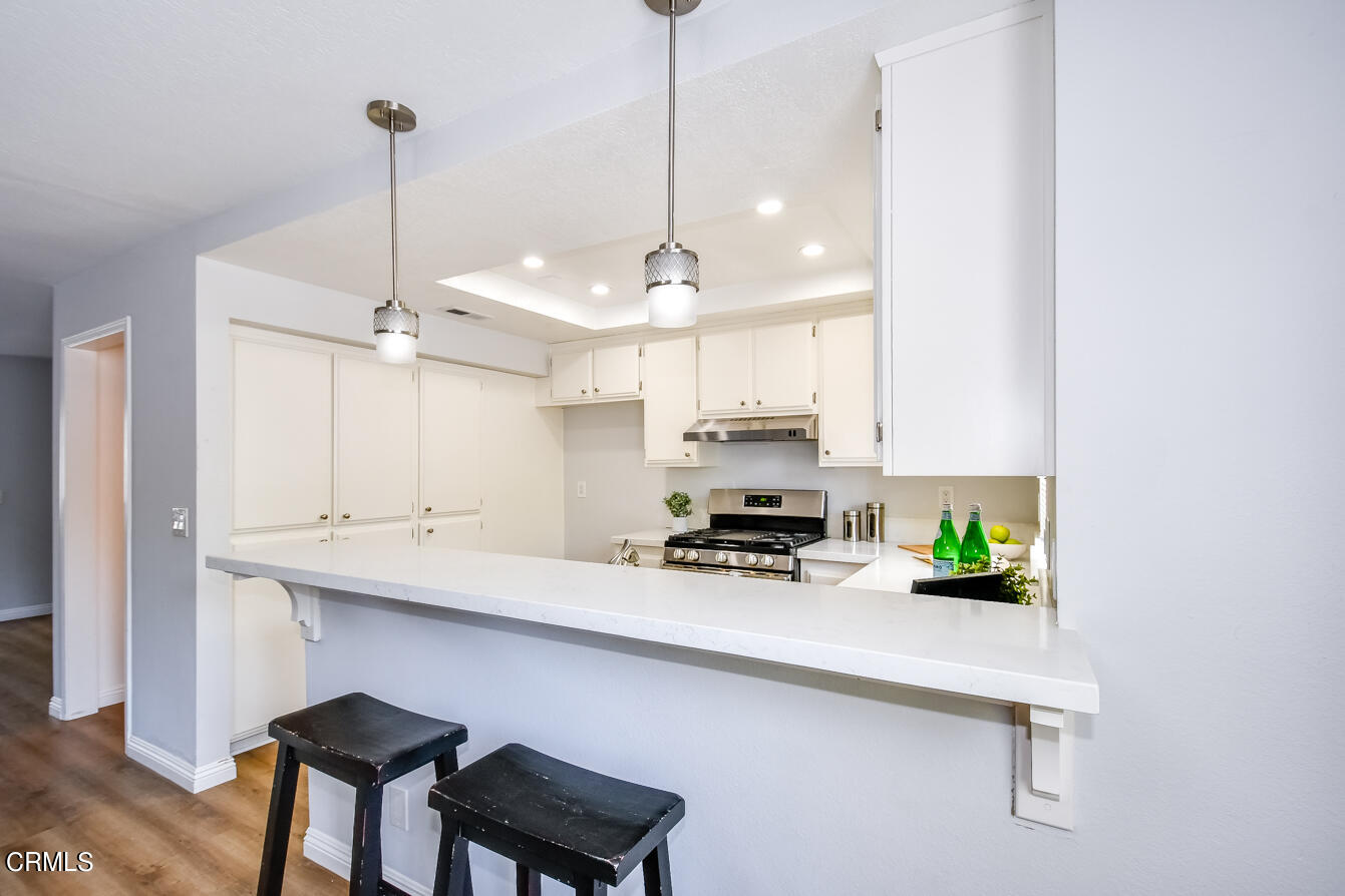 249 Alpine Street, Unit 53 Pasadena, CA 91106 - Photo 13 of 33 a kitchen with stainless steel appliances a stove a sink a refrigerator a center island a stove and a wooden floors