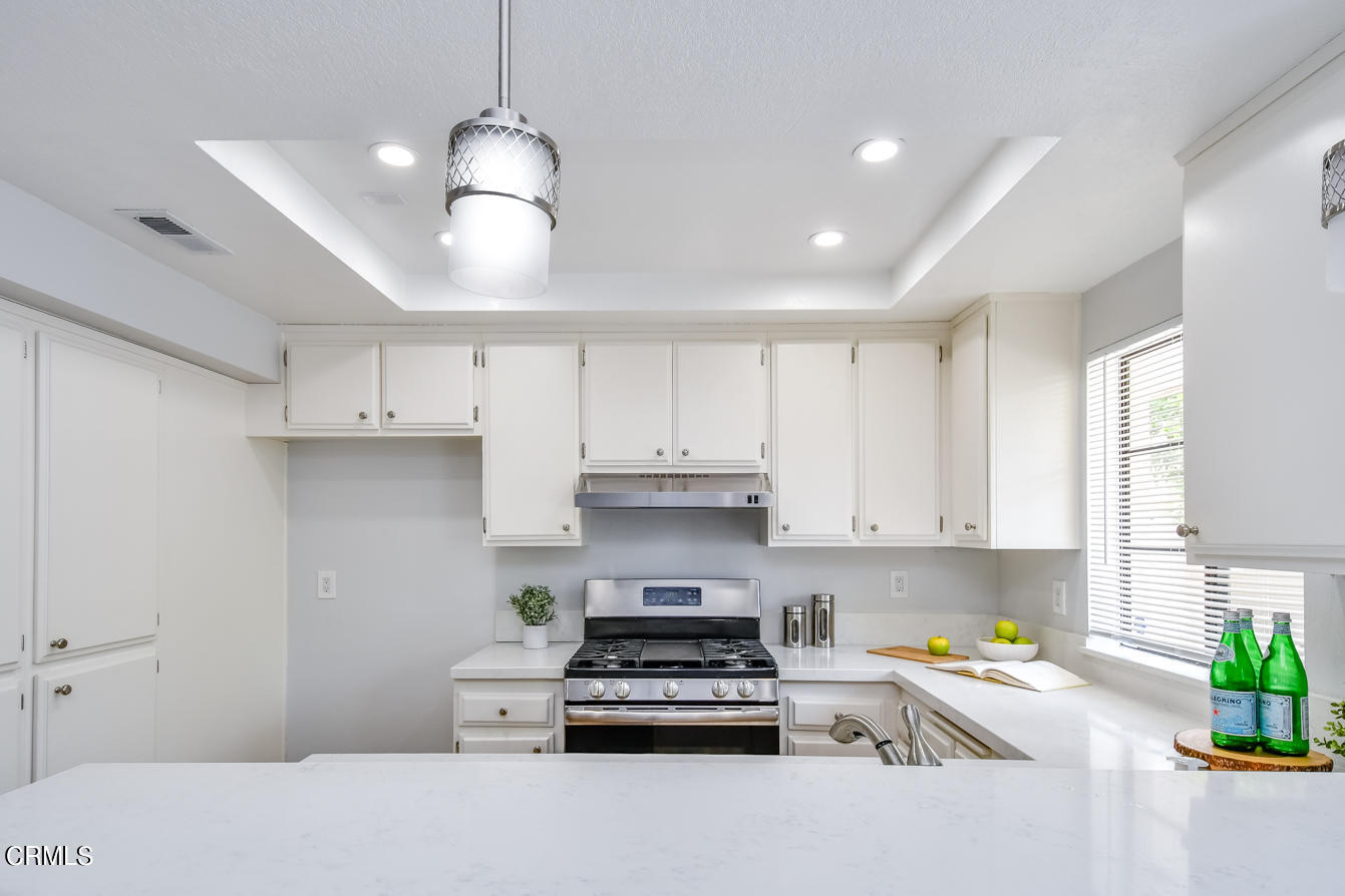249 Alpine Street, Unit 53 Pasadena, CA 91106 - Photo 14 of 33 a kitchen with granite countertop a stove and a sink