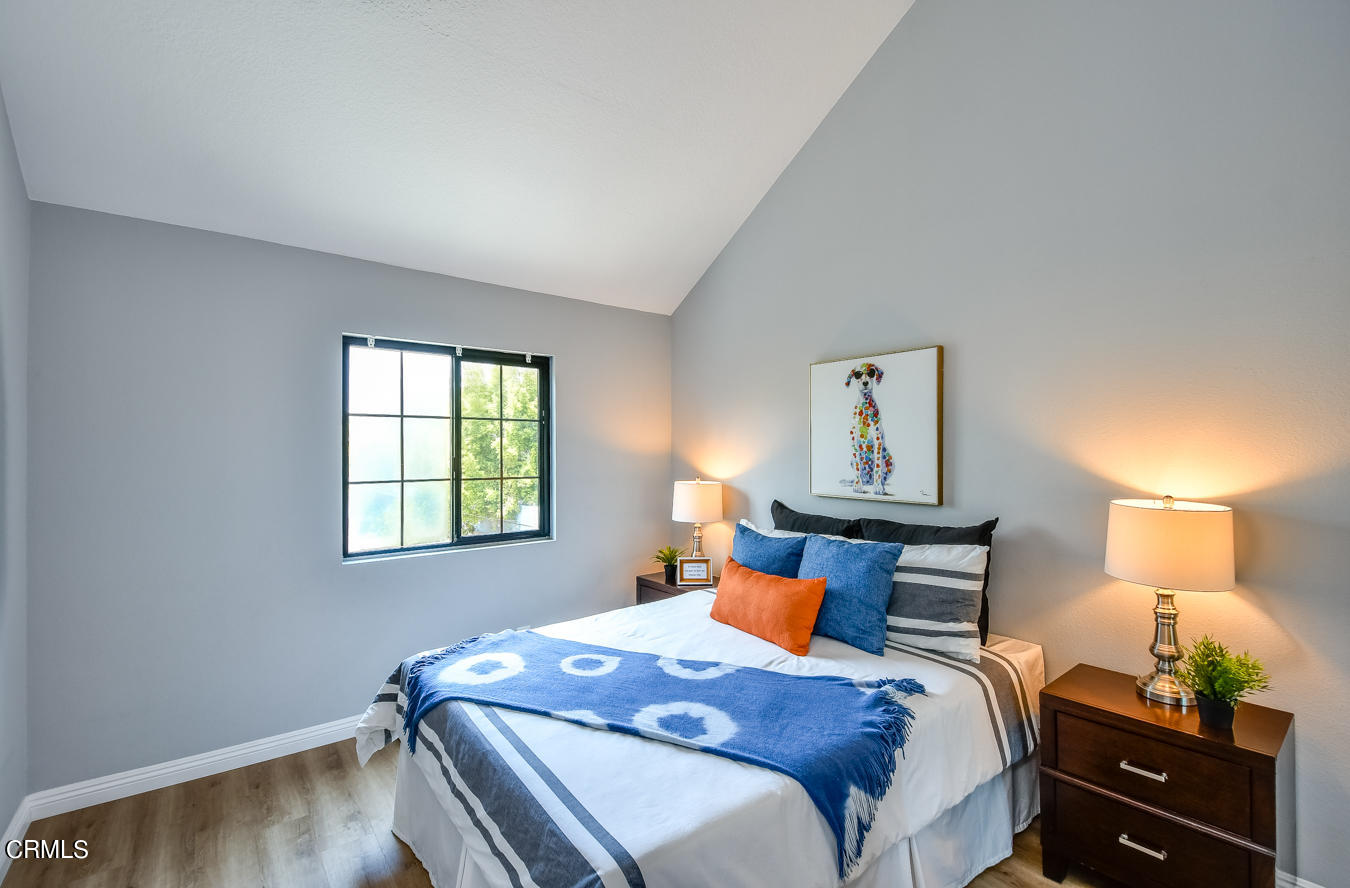 249 Alpine Street, Unit 53 Pasadena, CA 91106 - Photo 15 of 33 a bedroom with a bed and wooden floor