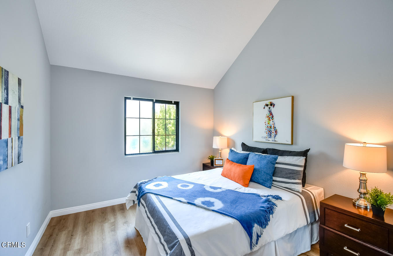 249 Alpine Street, Unit 53 Pasadena, CA 91106 - Photo 16 of 33 a bedroom with a bed and wooden floor