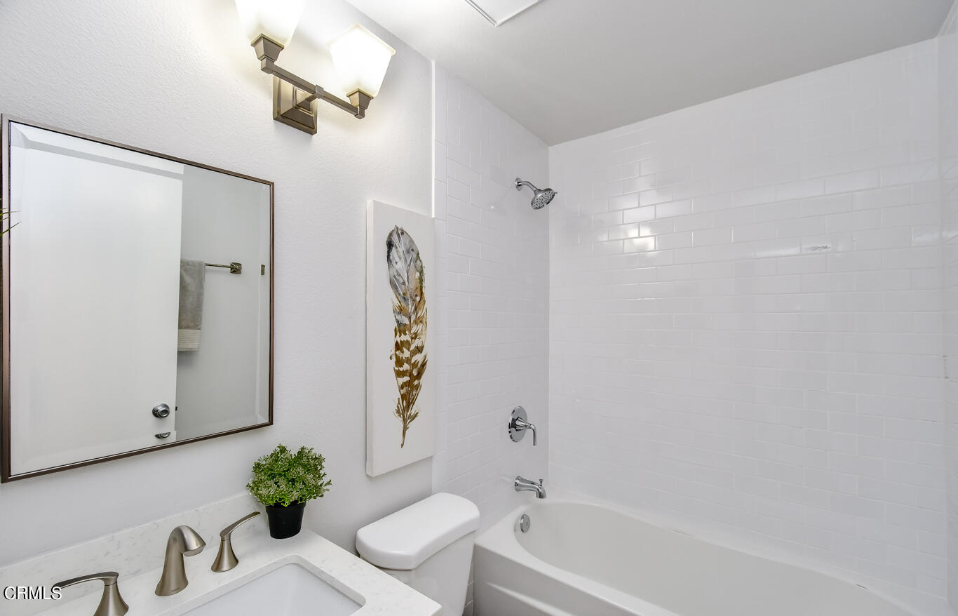 249 Alpine Street, Unit 53 Pasadena, CA 91106 - Photo 17 of 33 a bathroom with a bathtub shower and sink