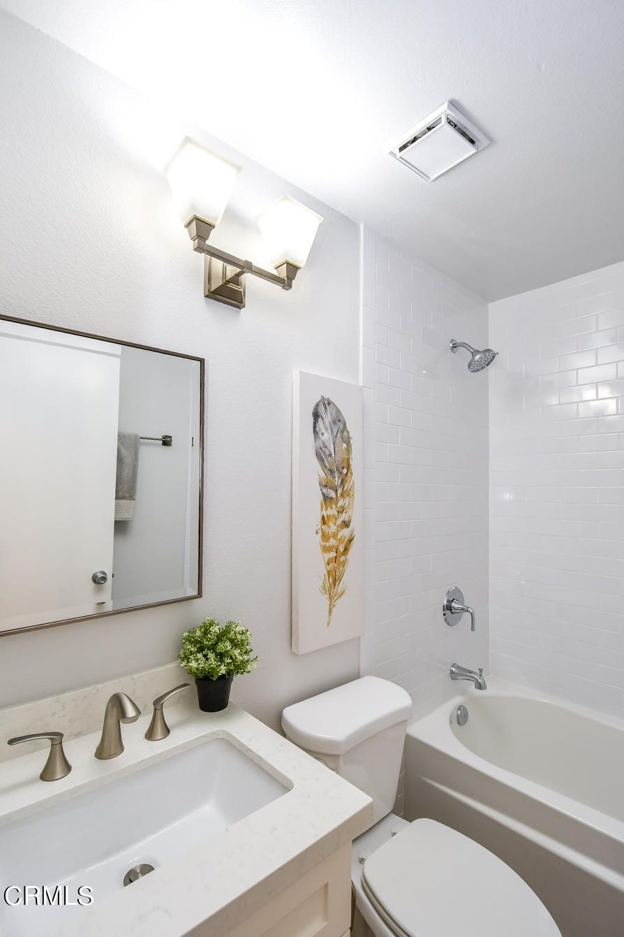 249 Alpine Street, Unit 53 Pasadena, CA 91106 - Photo 18 of 33 a bathroom with a granite countertop sink toilet a mirror and shower