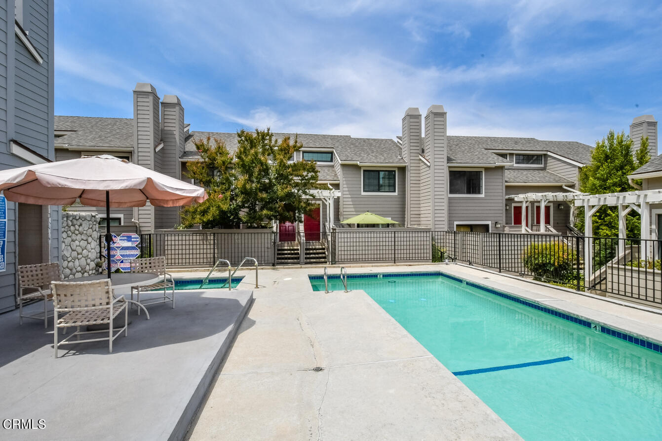 249 Alpine Street, Unit 53 Pasadena, CA 91106 - Photo 32 of 33 a patio with a table and chairs under an umbrella