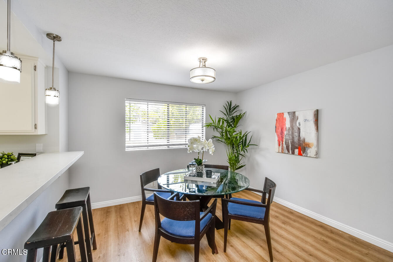 249 Alpine Street, Unit 53 Pasadena, CA 91106 - Photo 9 of 33 a view of a dining room with furniture and wooden floor
