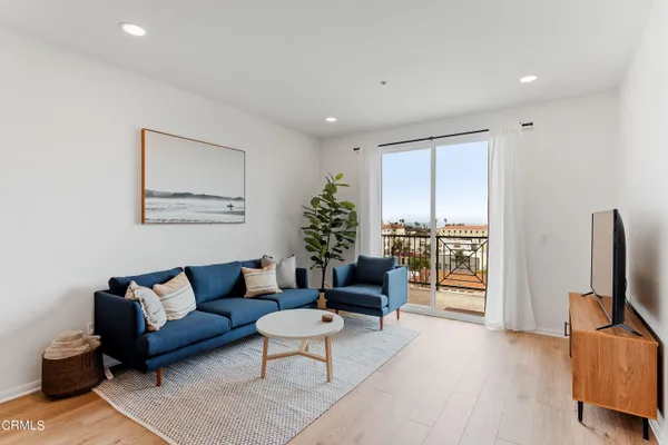a living room with furniture or couch and a flat screen tv