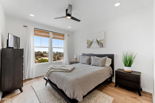 a bedroom with bed and a potted plant