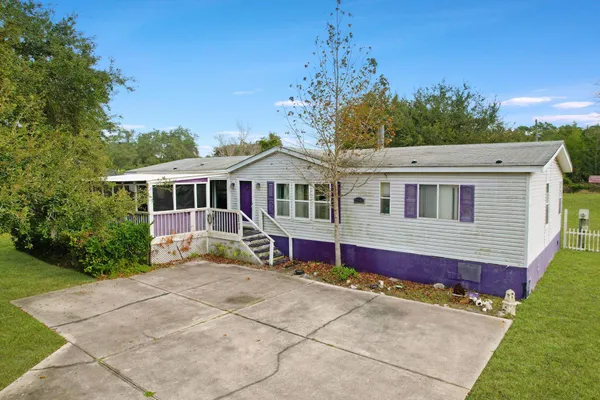 a view of house with outdoor space and swimming pool
