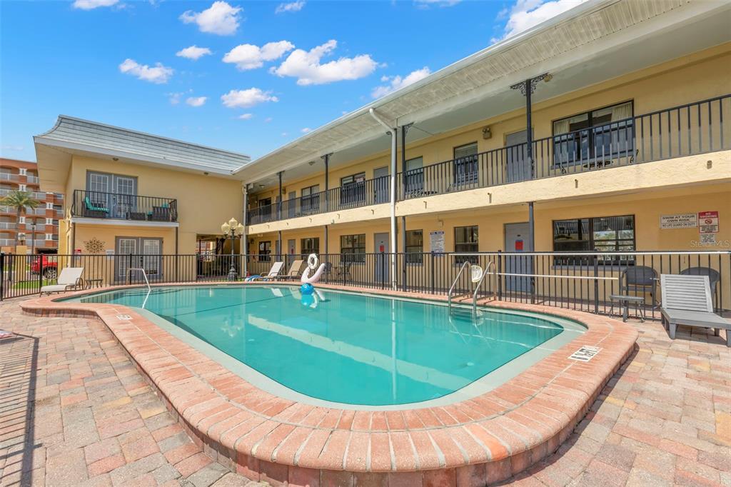 16333 Gulf Boulevard, Unit 113 Redington Beach, FL 33708 - Photo 20 of 40 a view of a swimming pool with an outdoor seating
