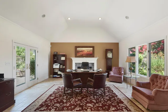 a work room with furniture and a large window