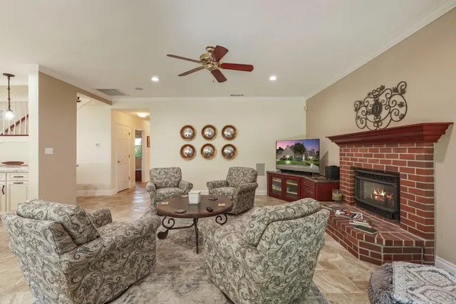 a living room with furniture a rug and a fireplace