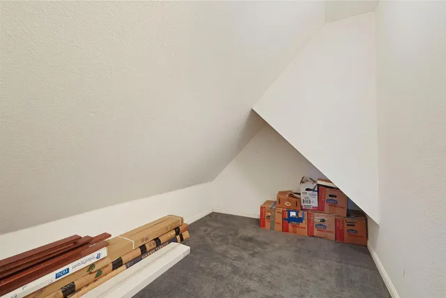 a view of a staircase with wooden floor and white walls