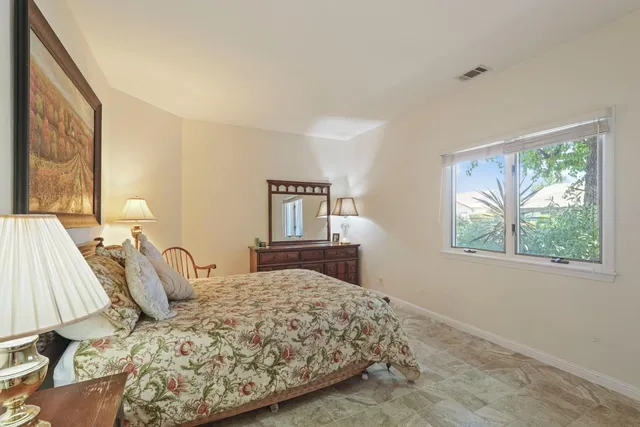 a bedroom with furniture and a window