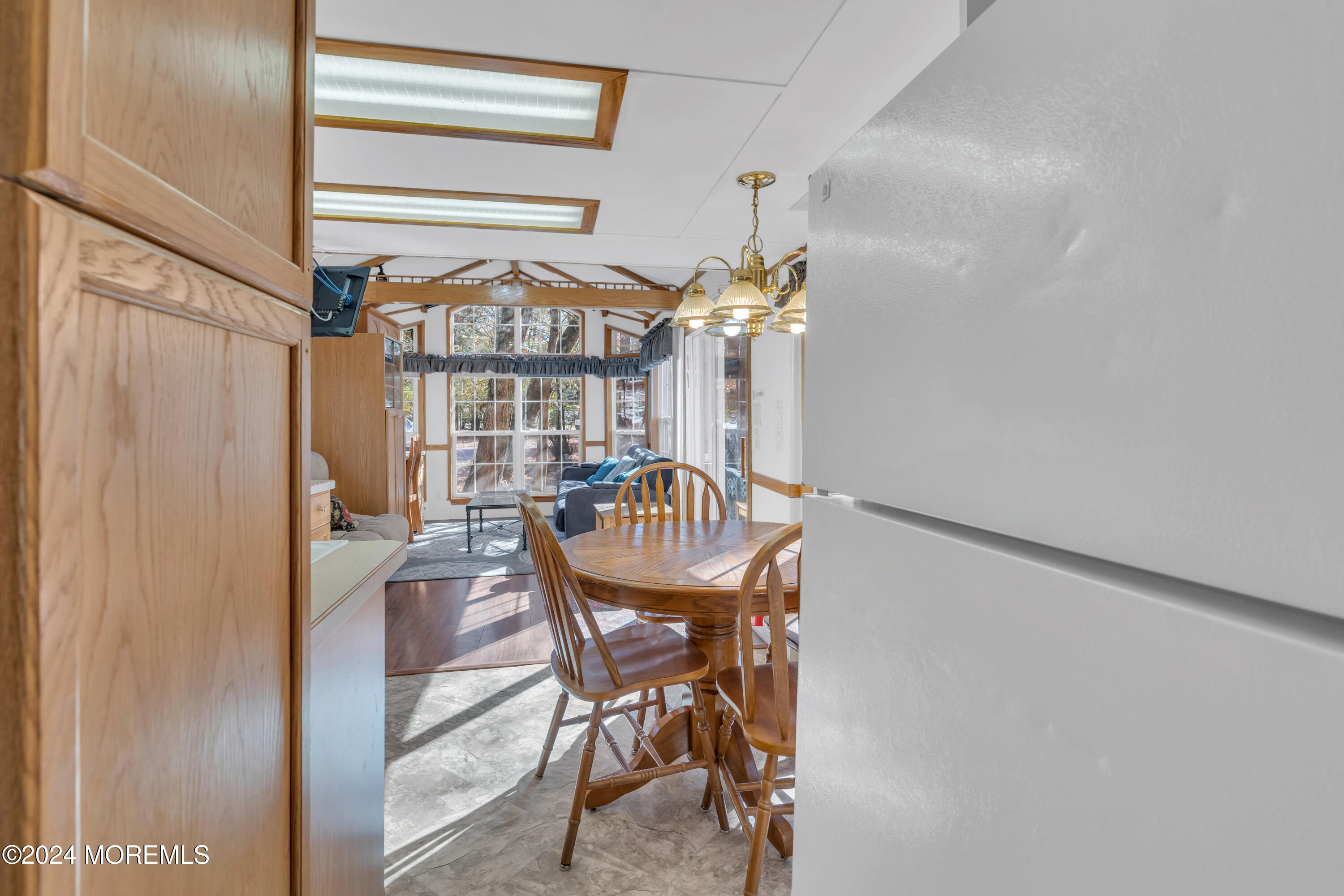 724 Monmouth Road, Unit 40 Cream Ridge, NJ 08514 - Photo 12 of 33 a view of a dining room with furniture window and wooden floor