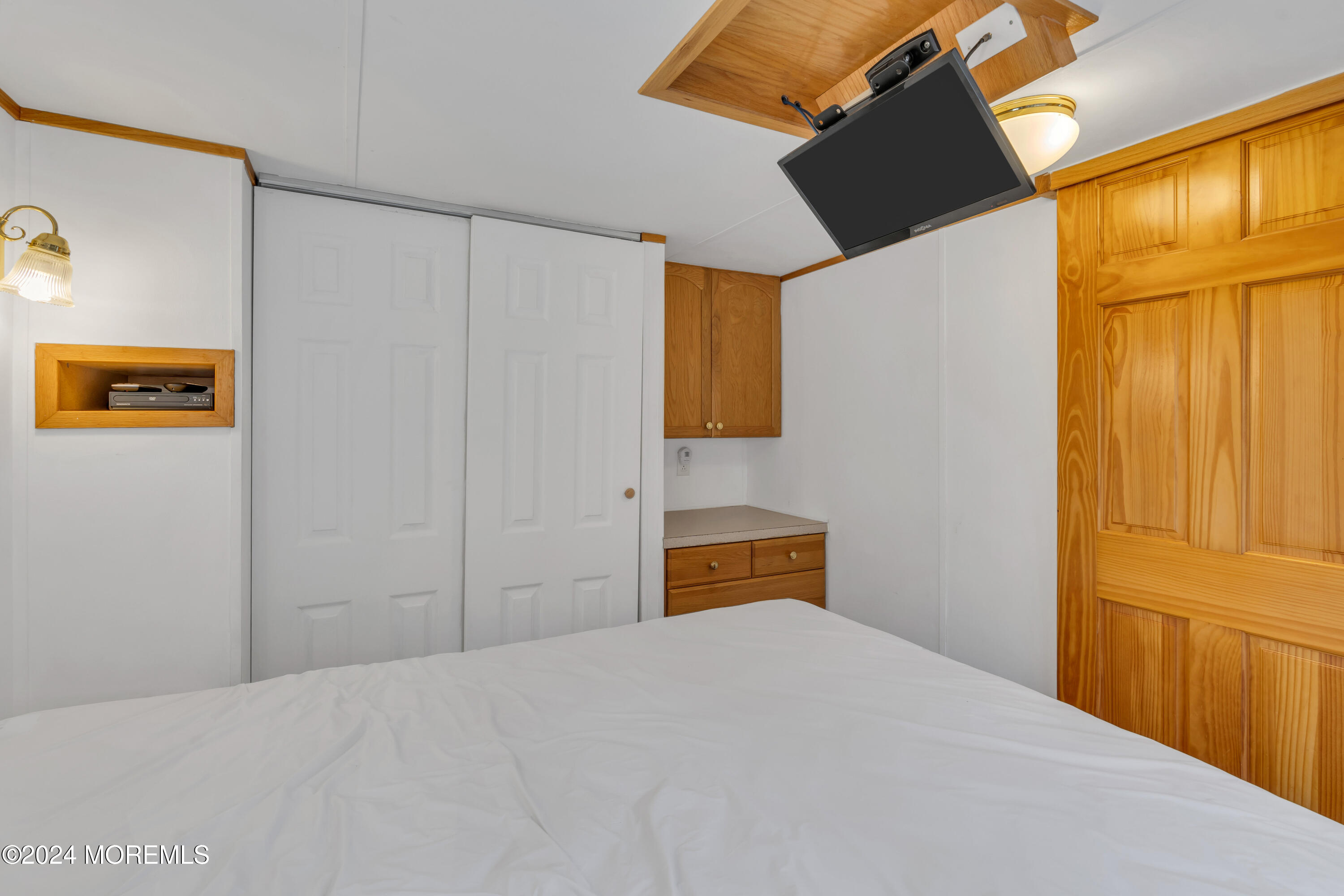 724 Monmouth Road, Unit 40 Cream Ridge, NJ 08514 - Photo 14 of 33 a bedroom with a bed and wooden floor