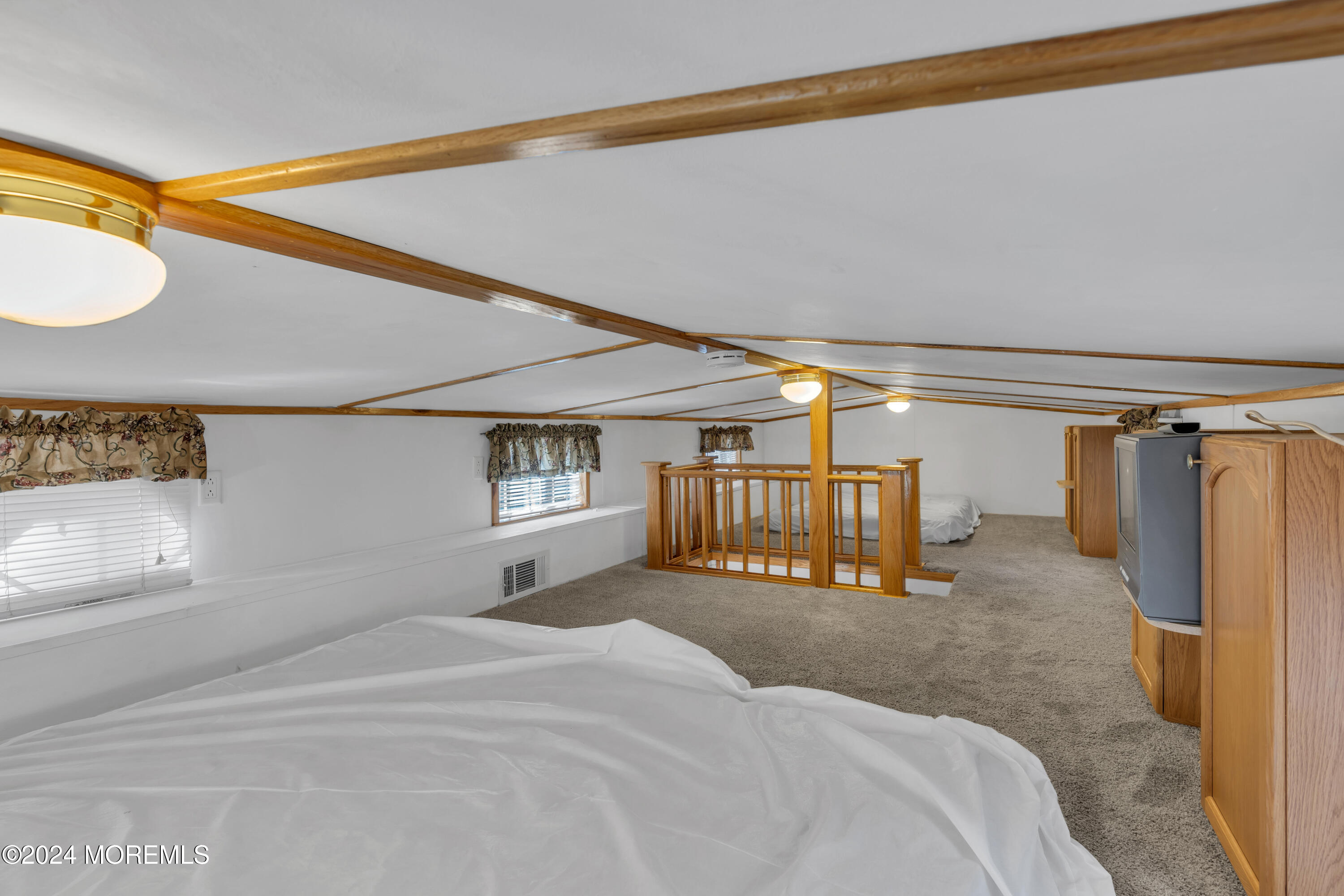 724 Monmouth Road, Unit 40 Cream Ridge, NJ 08514 - Photo 18 of 33 a bed room with a bed and a large mirror