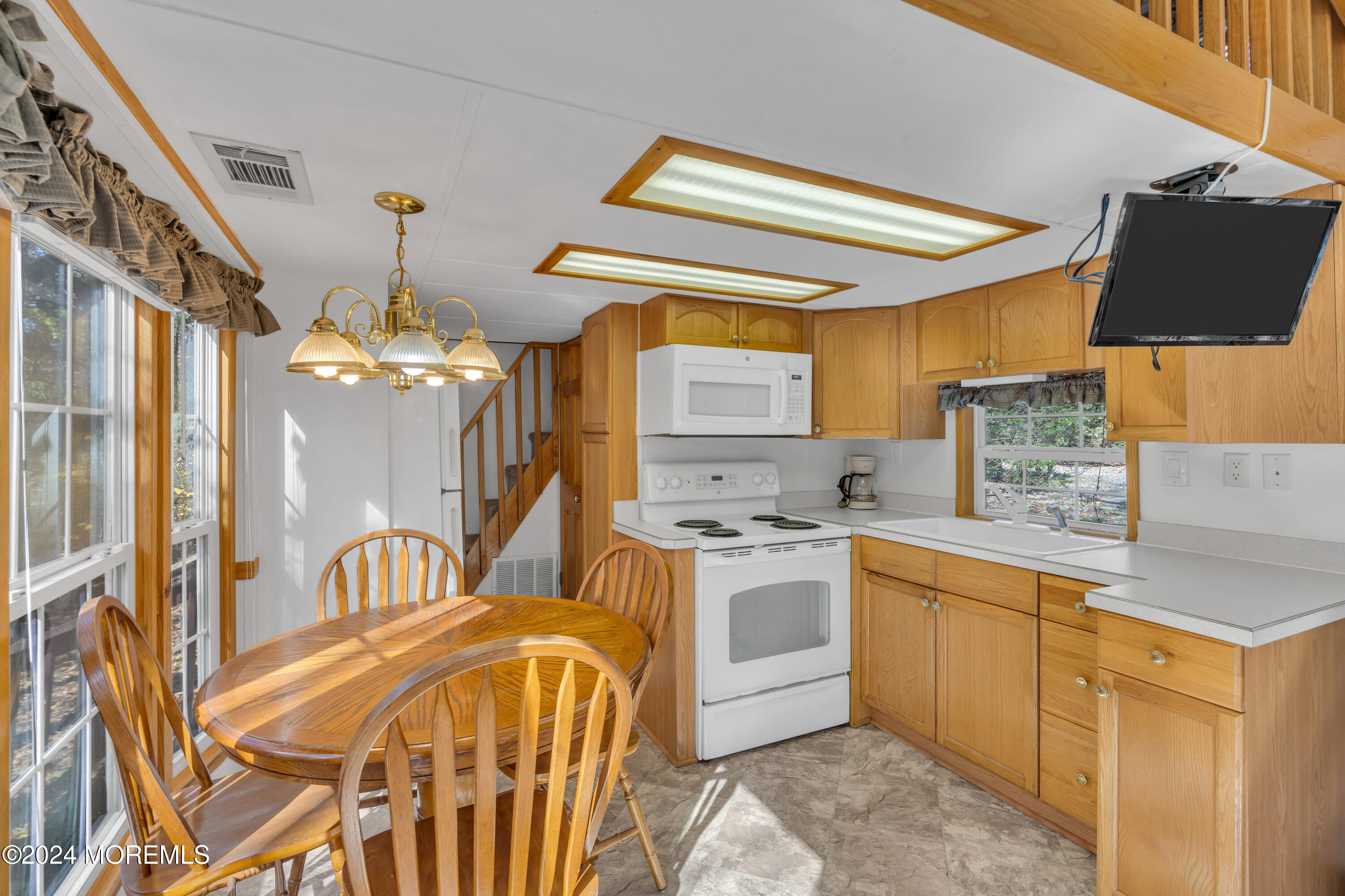 724 Monmouth Road, Unit 40 Cream Ridge, NJ 08514 - Photo 10 of 33 a kitchen with stainless steel appliances granite countertop a sink and cabinets