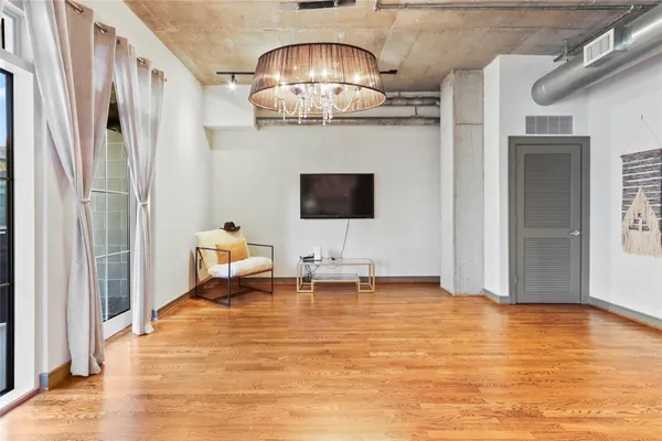 a view of a livingroom with furniture and a flat screen tv